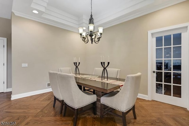 dining room with a chandelier, a raised ceiling, baseboards, crown molding, and recessed lighting