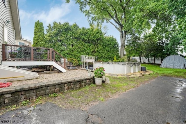 view of yard with a deck and a patio area