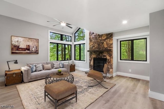 19 Village Way Unit 7H, Vernon Twp, NJ 07462 - living area with baseboards, ceiling fan, a stone fireplace, light wood-style flooring, and lofted ceiling
