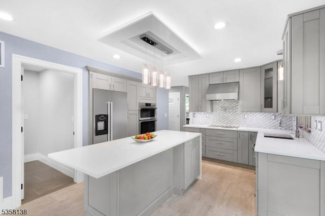 19 Village Way Unit 7H, Vernon Twp, NJ 07462 - kitchen featuring gray cabinetry, stainless steel appliances, a sink, light wood-style floors, and decorative backsplash