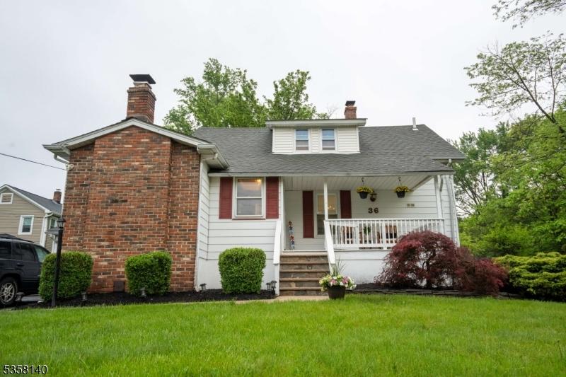 36 Woodlawn Ave, Bridgewater Twp, NJ 08807 - bungalow with a chimney, a porch, a front lawn, and a shingled roof