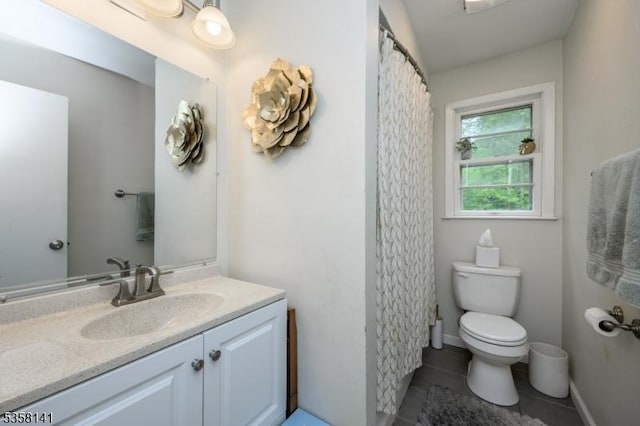 full bath featuring toilet, vanity, and tile patterned floors