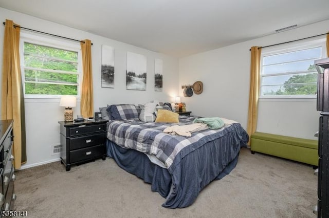 bedroom featuring light carpet