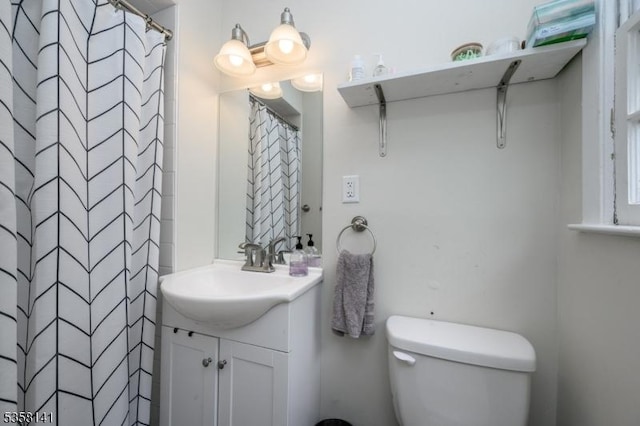 bathroom with vanity, toilet, and a shower with curtain