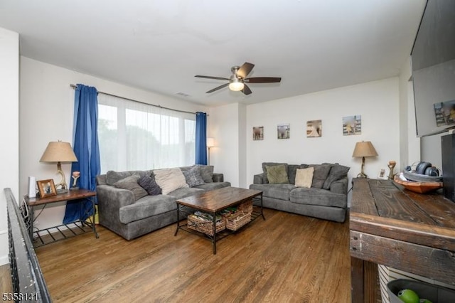 living area with wood finished floors and ceiling fan