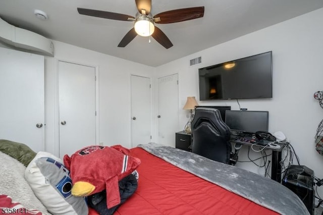 bedroom featuring an office area and ceiling fan