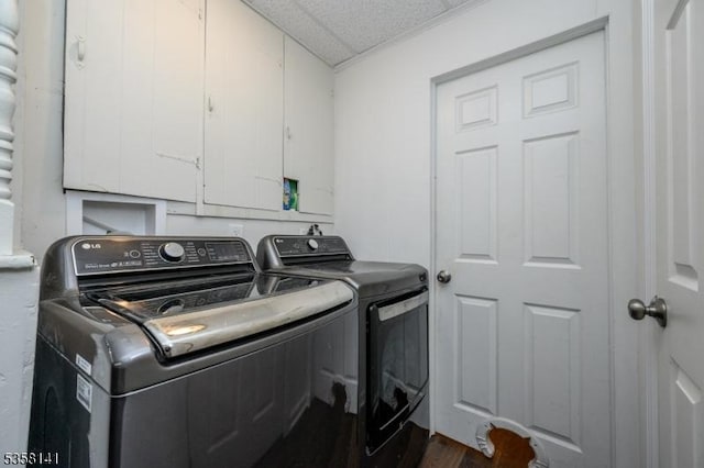 laundry room featuring separate washer and dryer and dark wood finished floors
