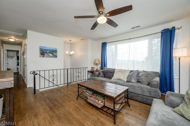 living area with ceiling fan, dark wood-type flooring, and attic access