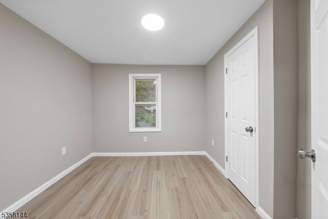 unfurnished bedroom featuring light wood-type flooring and baseboards