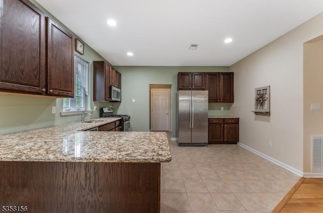 109 Samson Dr, Raritan Twp, NJ 08822 - kitchen featuring stainless steel appliances, a sink, light stone countertops, a peninsula, and dark brown cabinets