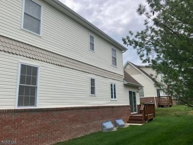 109 Samson Dr, Raritan Twp, NJ 08822 - rear view of property with brick siding, a wooden deck, and a lawn