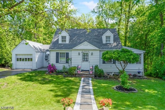 cape cod house featuring driveway, an attached garage, and a front yard