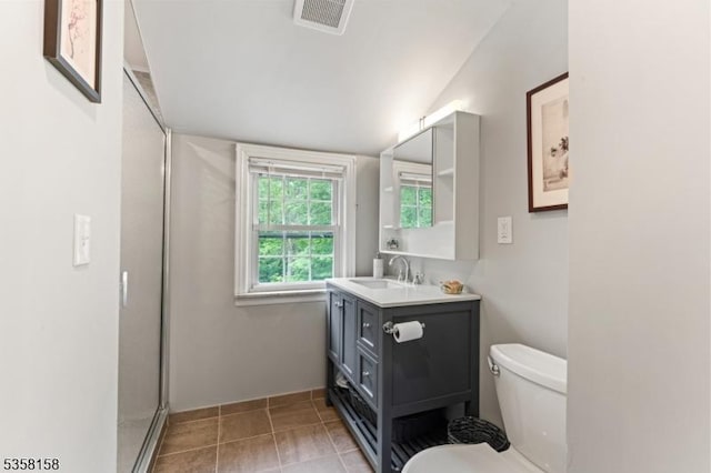 full bathroom featuring toilet, vanity, a shower with shower door, tile patterned floors, and lofted ceiling