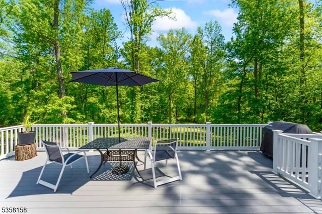 wooden deck with outdoor dining area