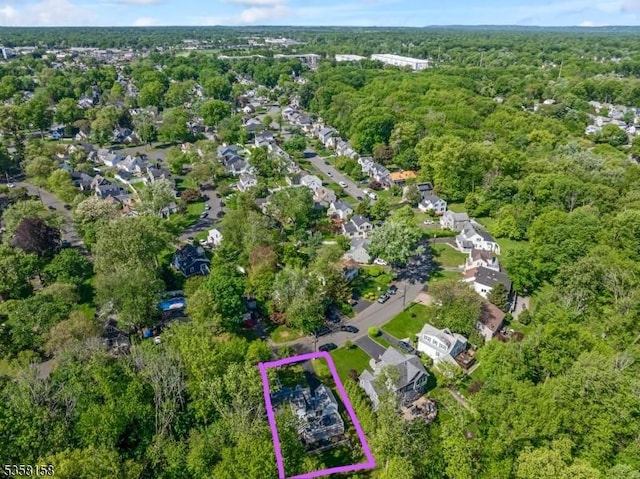 aerial view of property's location with property boundaries highlighted and a heavily wooded area