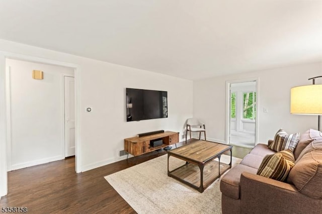 living room with dark wood finished floors and baseboards