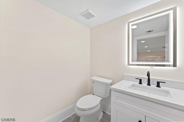 bathroom with baseboards, toilet, and vanity