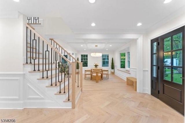 entryway with a decorative wall, stairs, a wainscoted wall, recessed lighting, and coffered ceiling