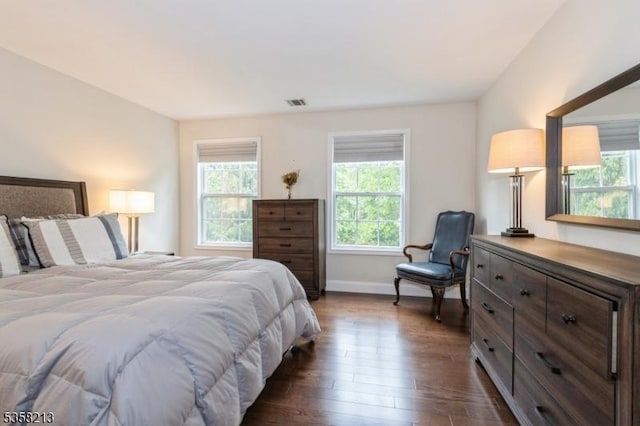 bedroom featuring dark wood-type flooring and baseboards