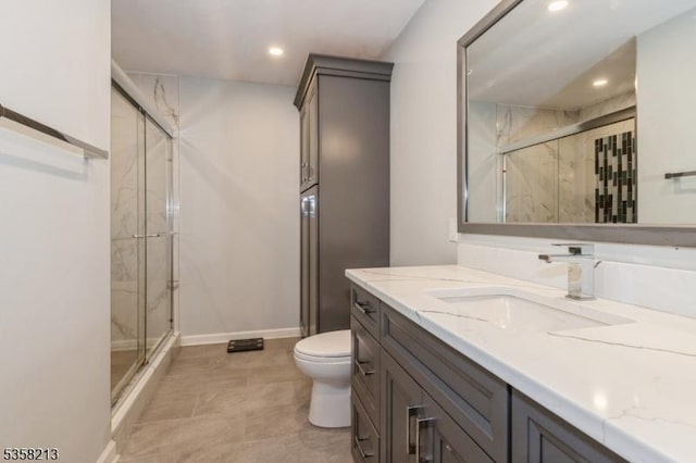 bathroom featuring a stall shower, toilet, recessed lighting, vanity, and baseboards