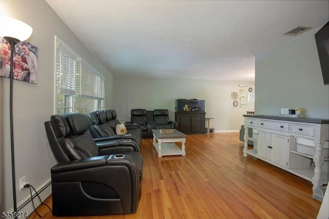 living area featuring a baseboard radiator and light wood finished floors