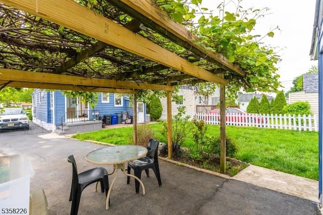view of patio / terrace with a pergola and outdoor dining space