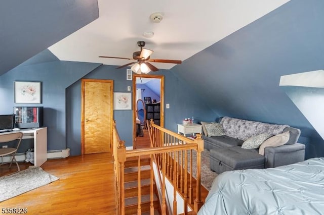 bedroom with wood finished floors, vaulted ceiling, and a ceiling fan