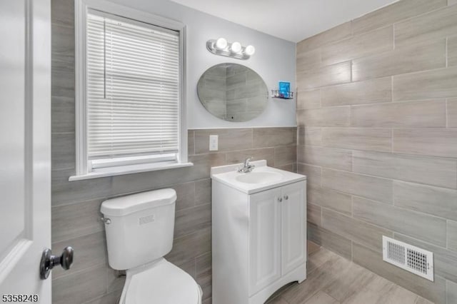 227 N Center St, City Of Orange Twp, NJ 07050 - bathroom with tile walls, toilet, and vanity