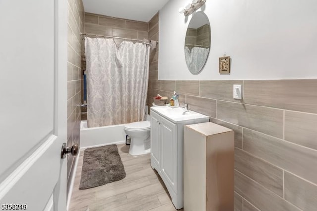 227 N Center St, City Of Orange Twp, NJ 07050 - bathroom featuring tile walls, vanity, shower / tub combo, and toilet