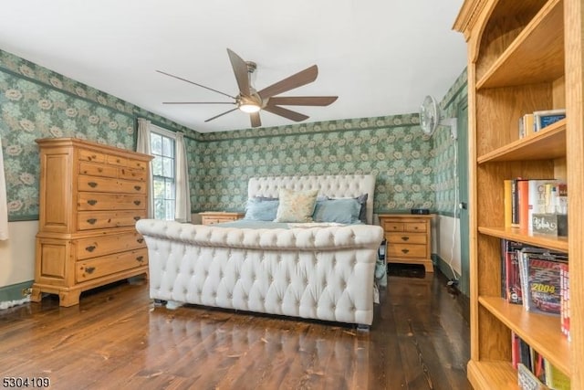 bedroom with wallpapered walls, dark wood-style flooring, and ceiling fan