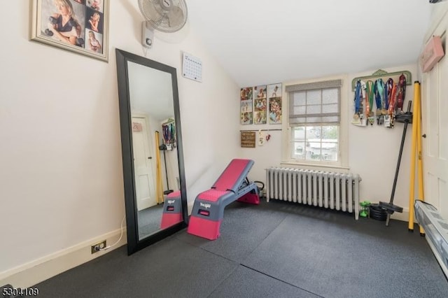 living area with radiator heating unit and vaulted ceiling