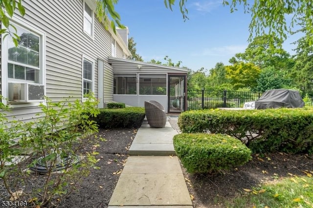 view of yard featuring a sunroom, fence, and cooling unit