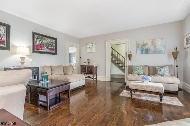living room with wood finished floors, stairs, and baseboards
