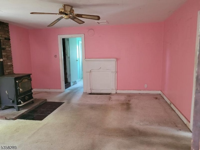68 Route31, Oxford Twp, NJ 07863 - unfurnished living room featuring a wood stove, carpet, baseboards, and ceiling fan