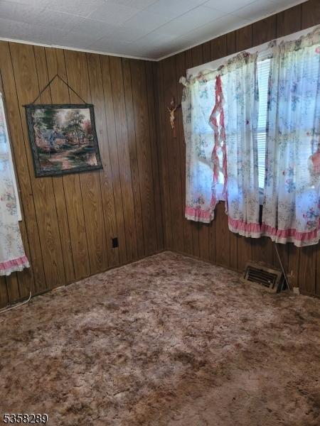 68 Route31, Oxford Twp, NJ 07863 - carpeted empty room featuring wood walls