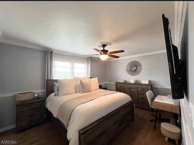 bedroom with crown molding, dark wood-style flooring, and a ceiling fan