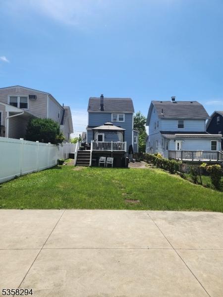back of property with a residential view and a patio
