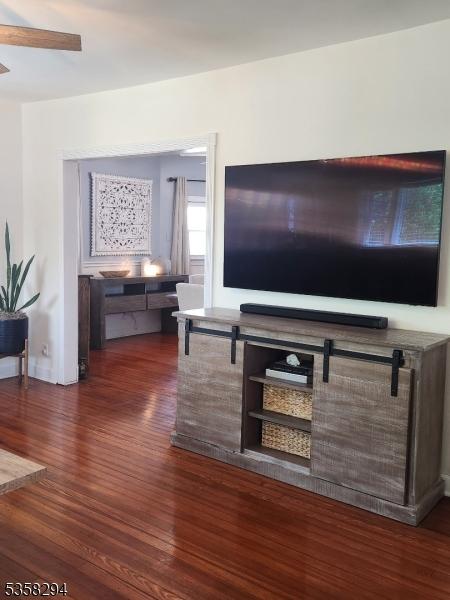 living area featuring wood finished floors and ceiling fan