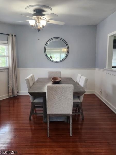 dining room featuring ceiling fan, hardwood / wood-style flooring, and baseboards