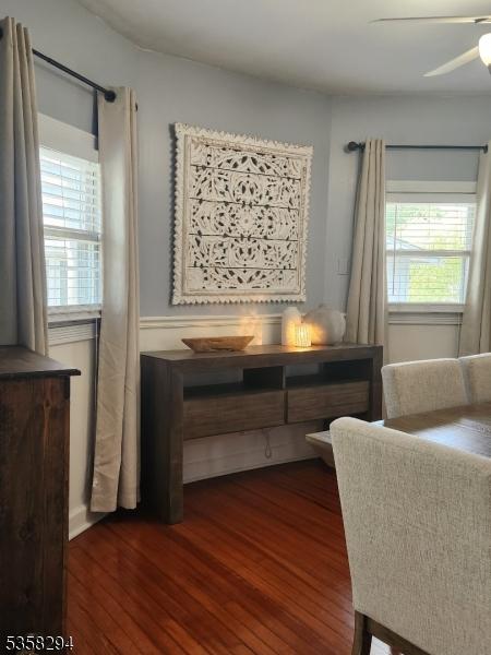 dining room featuring dark wood finished floors and a ceiling fan