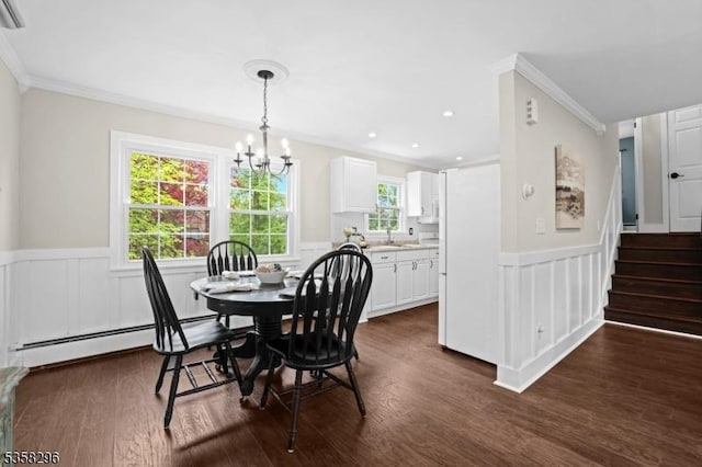 25 Hunter St, Roxbury Twp, NJ 07876 - dining room with ornamental molding, a wainscoted wall, a chandelier, dark wood-type flooring, and healthy amount of natural light