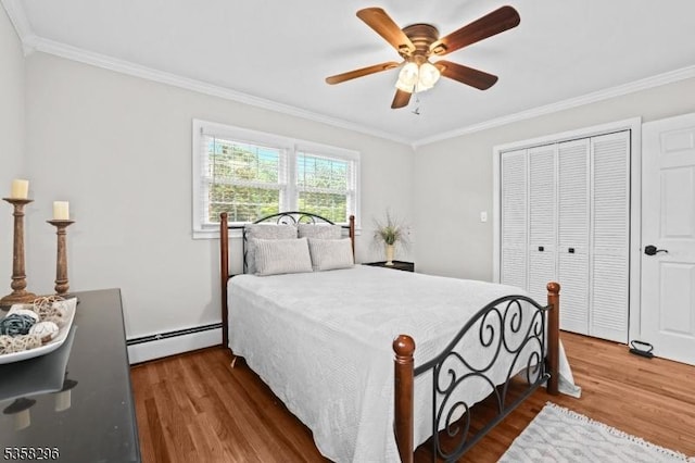25 Hunter St, Roxbury Twp, NJ 07876 - bedroom with baseboard heating, ornamental molding, wood finished floors, a closet, and ceiling fan