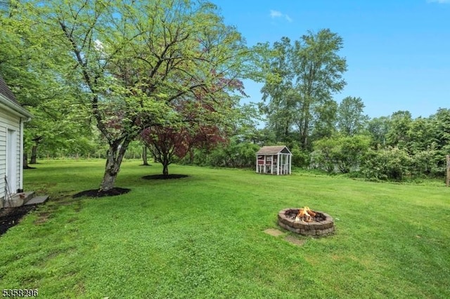 25 Hunter St, Roxbury Twp, NJ 07876 - view of green lawn featuring a fire pit and a storage unit