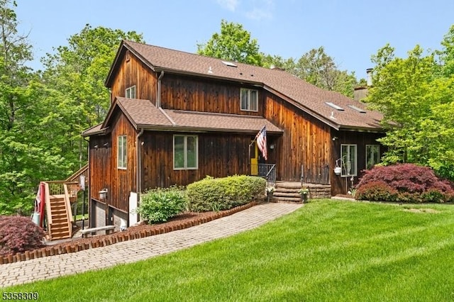 67 Brookwood Rd, Byram Twp, NJ 07874 - chalet / cabin featuring a front lawn, stairs, a chimney, and an attached garage