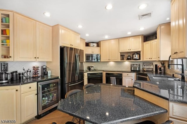 67 Brookwood Rd, Byram Twp, NJ 07874 - kitchen with stainless steel microwave, wine cooler, freestanding refrigerator, black oven, and a sink