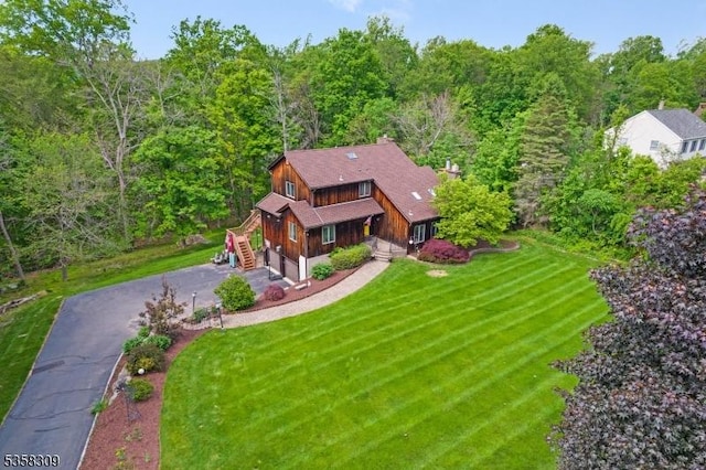 67 Brookwood Rd, Byram Twp, NJ 07874 - view of front of home with driveway, a front yard, an attached garage, stairs, and a forest view