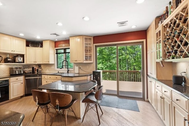 67 Brookwood Rd, Byram Twp, NJ 07874 - kitchen with dishwasher, a sink, a kitchen bar, oven, and light wood-type flooring
