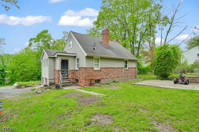 104 Lake Park Ter, West Milford Twp, NJ 07421 - back of house featuring a chimney, a lawn, brick siding, entry steps, and roof with shingles