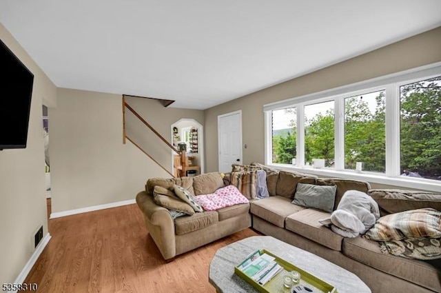 104 Lake Park Ter, West Milford Twp, NJ 07421 - living area featuring light wood finished floors, stairs, baseboards, and arched walkways