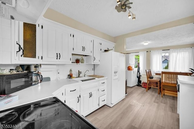 104 Lake Park Ter, West Milford Twp, NJ 07421 - kitchen featuring a sink, black appliances, light wood-type flooring, and white cabinets